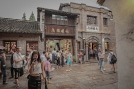 A group of travelers exploring a picturesque city street filled with local culture.