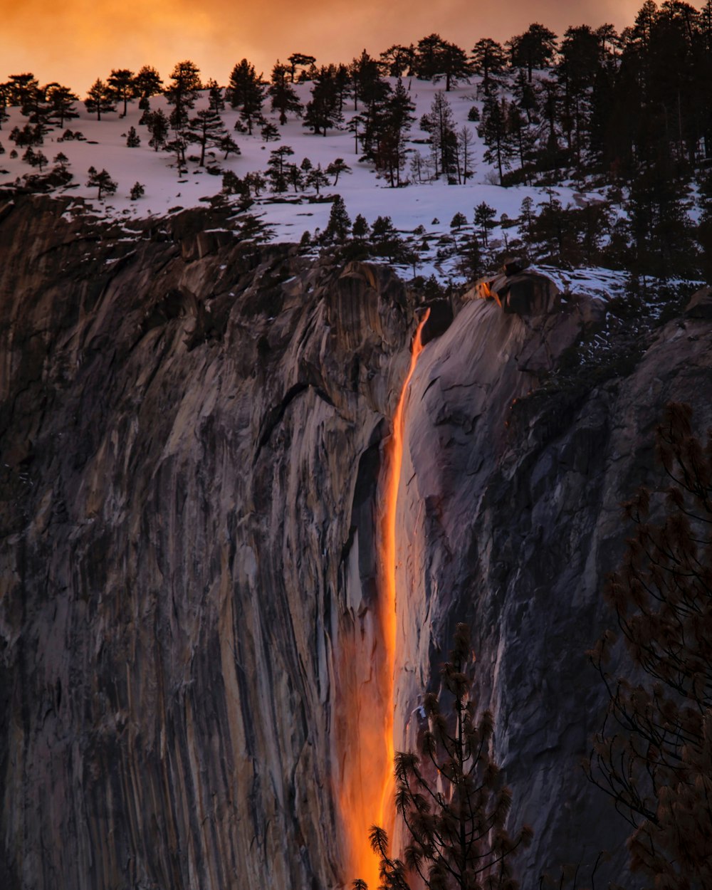 waterfalls near cliff at golden hour