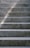 Close-up of smooth, freshly finished concrete steps with subtle broom texture in natural light.
