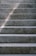 Close-up of smooth, freshly finished concrete steps with subtle broom texture in natural light.