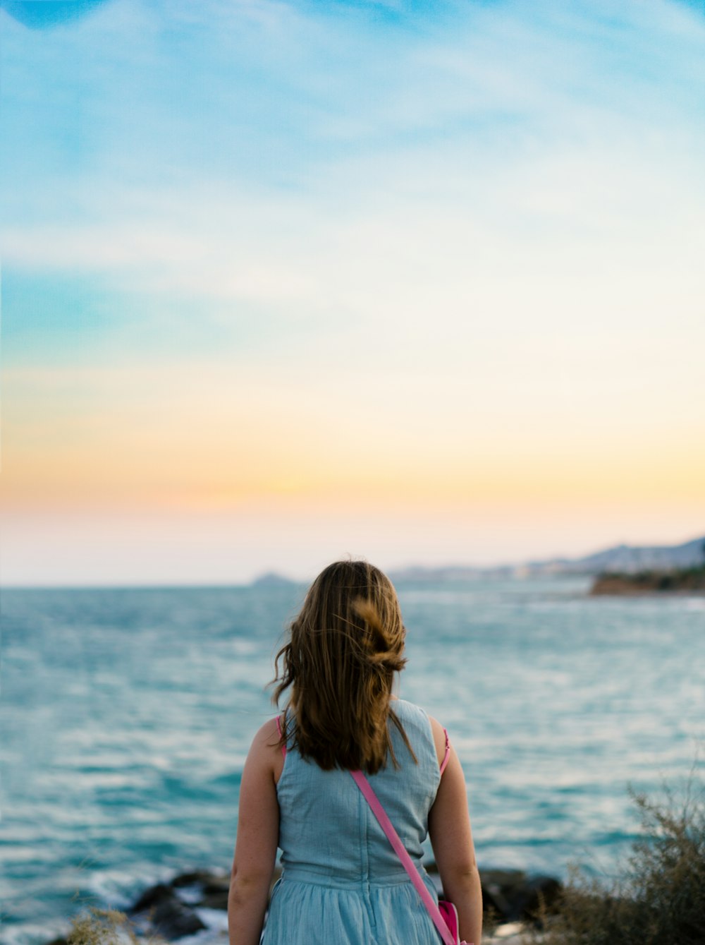 woman standing near body of water