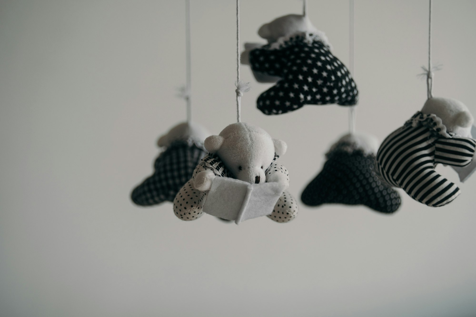 black and white bears hanging from a mobile