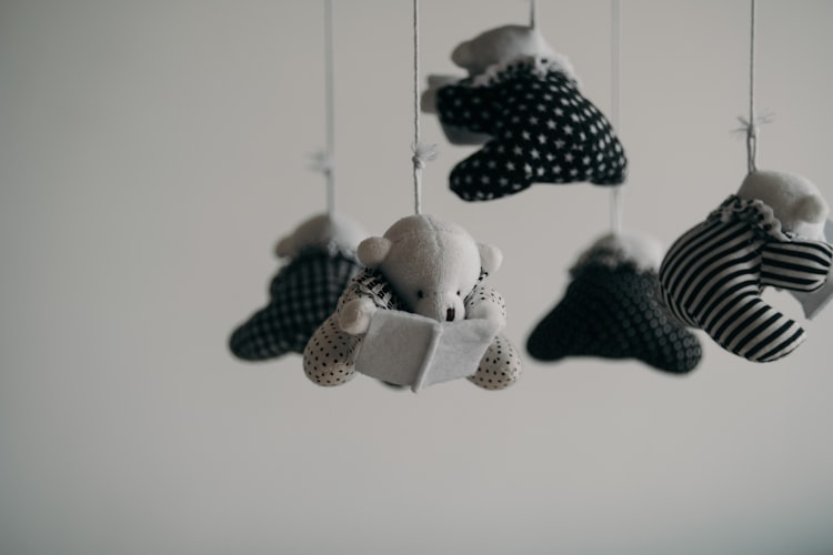 black and white bears hanging from a mobile