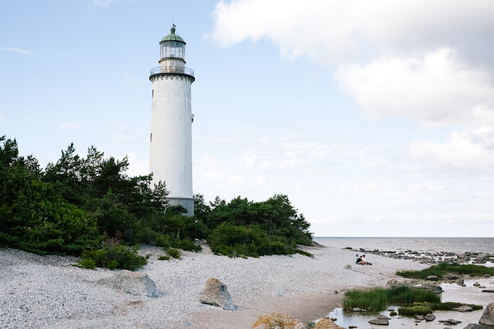 white lighthouse near body of water