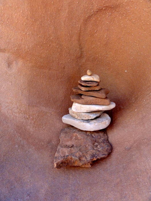 Stack of various natural stone tiles including granite and travertine displayed neatly