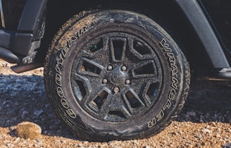 black vehicle wheel with uneven wear and cracks