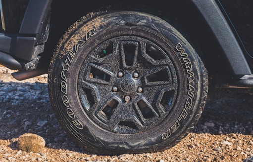 black vehicle wheel with uneven wear and cracks