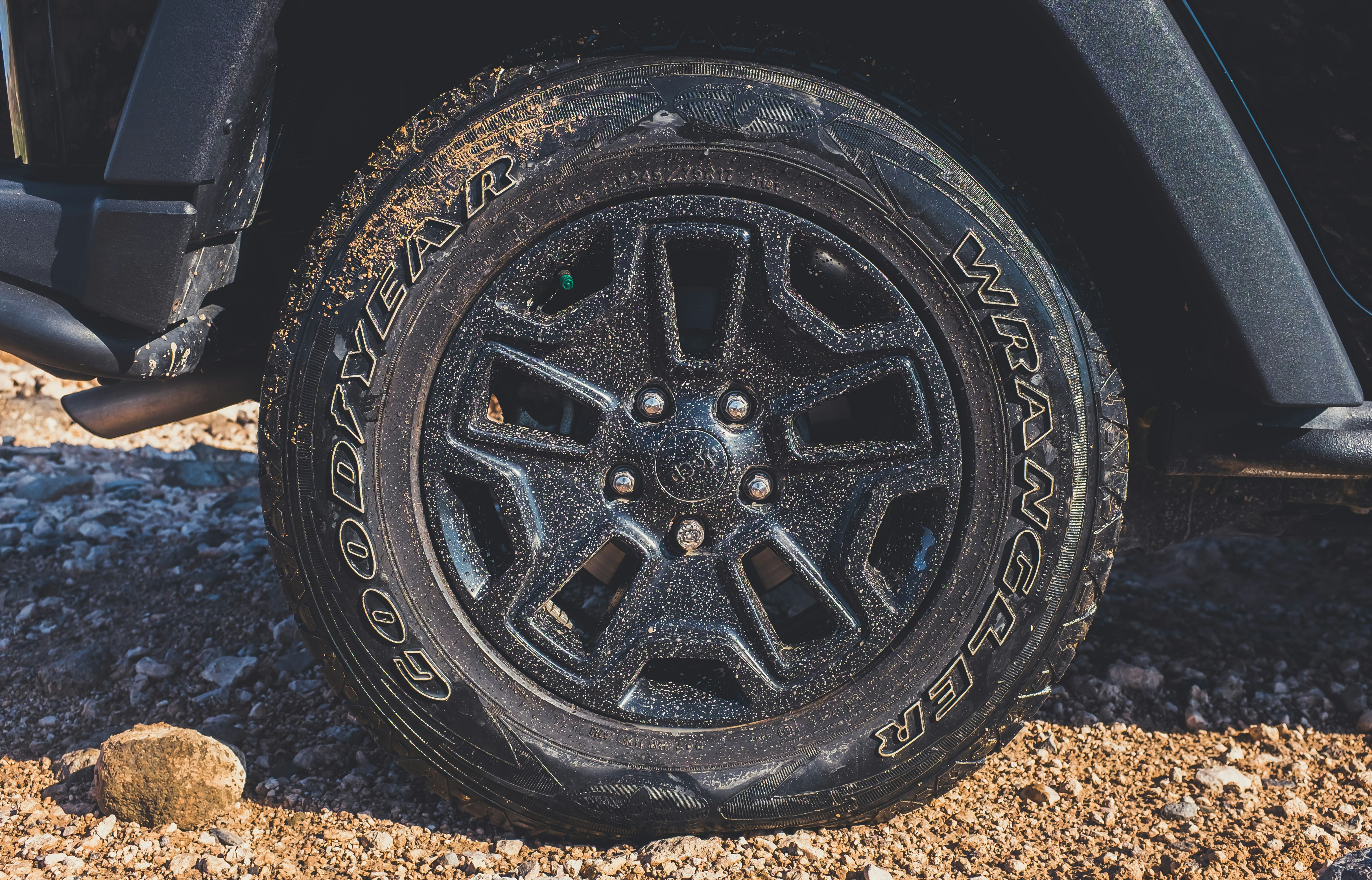 black vehicle wheel with Wrangler tire