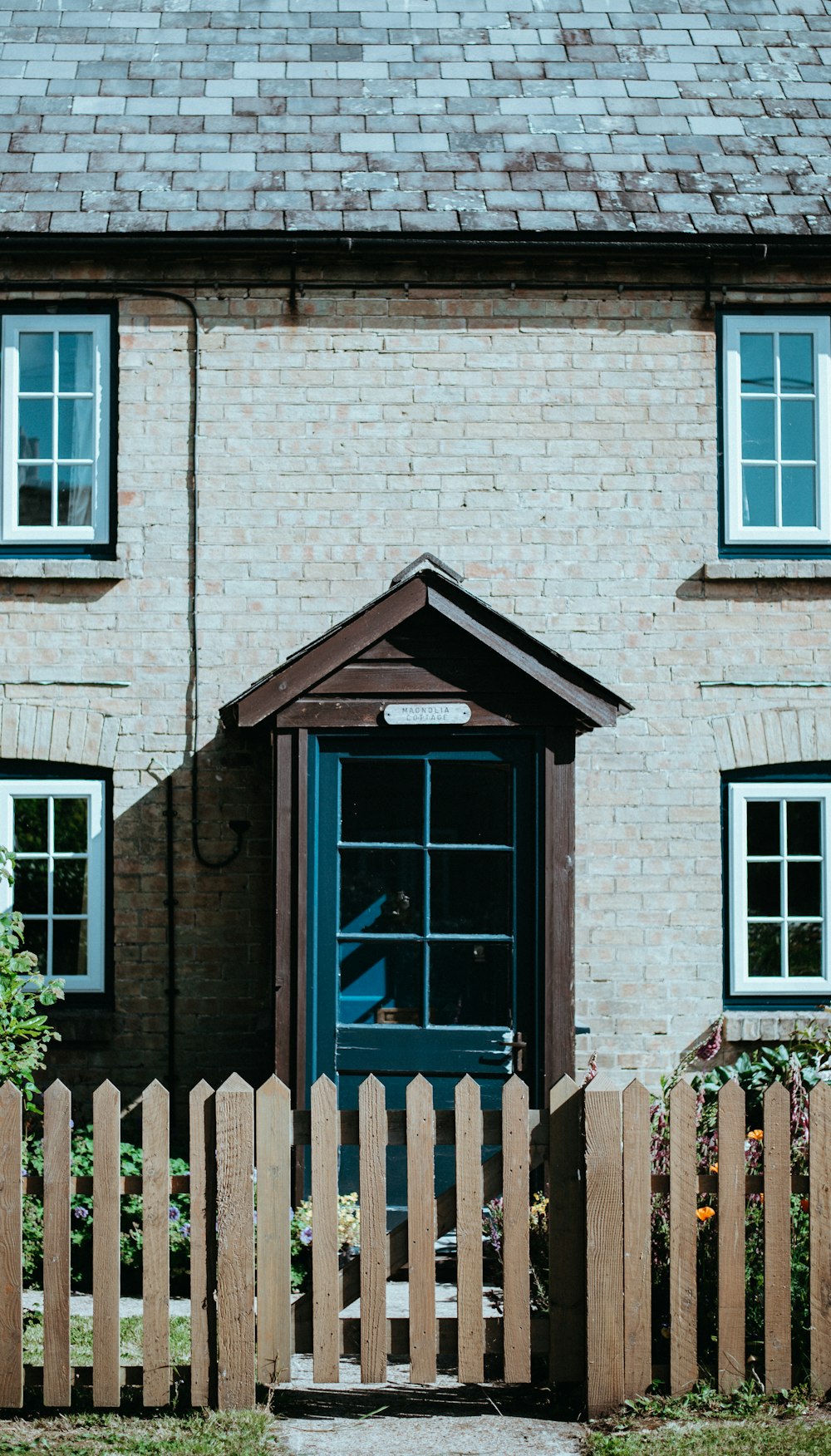 brown wooden fence in front of house