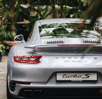 selective focus photography of silver Porsche coupe