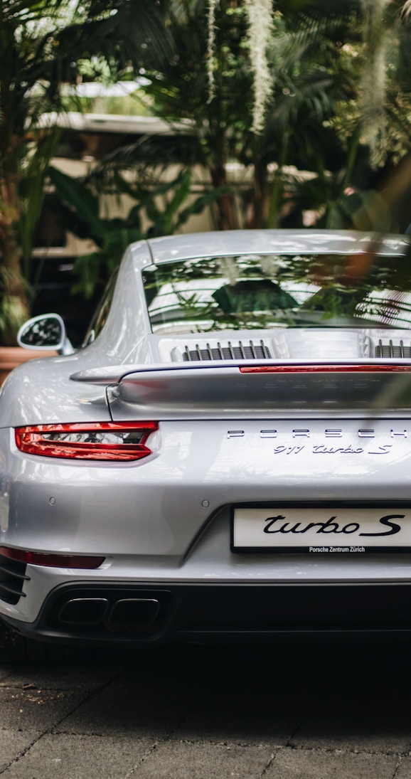 selective focus photography of silver Porsche coupe