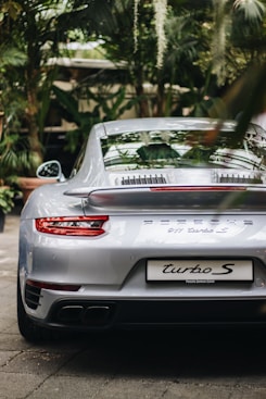 selective focus photography of silver Porsche coupe