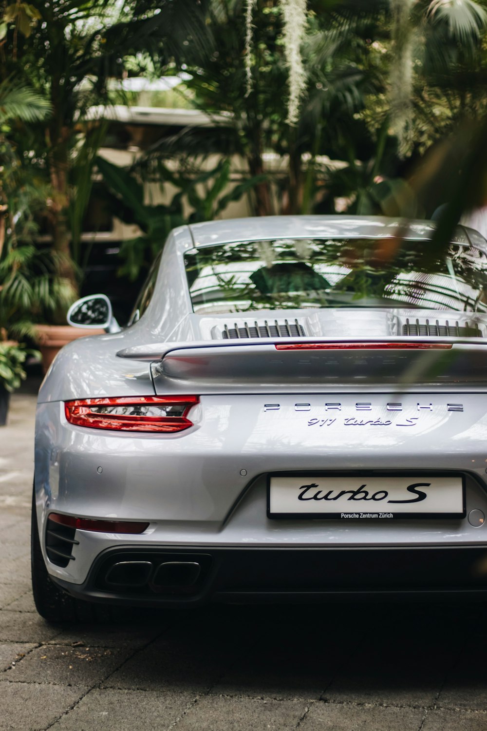 selective focus photography of silver Porsche coupe