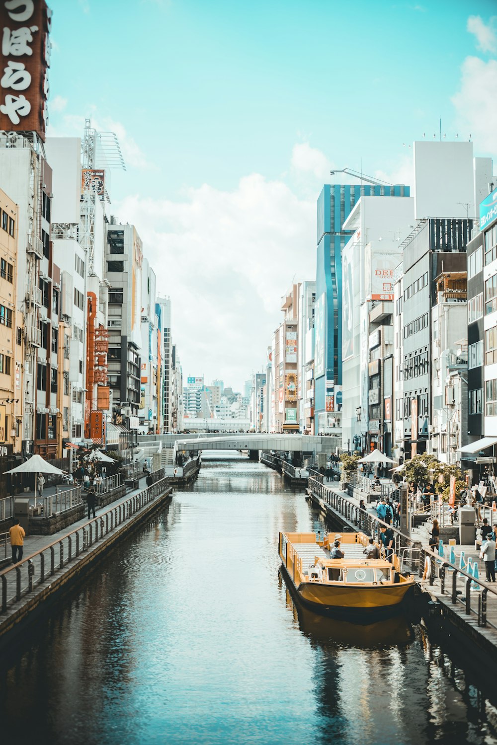 river in between street and high rise buildings