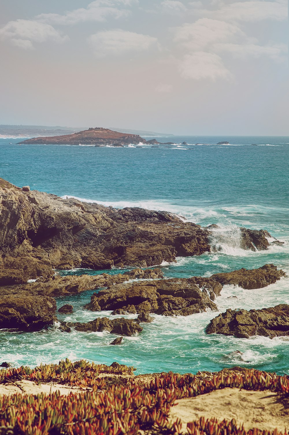 rock formation near ocean at daytime