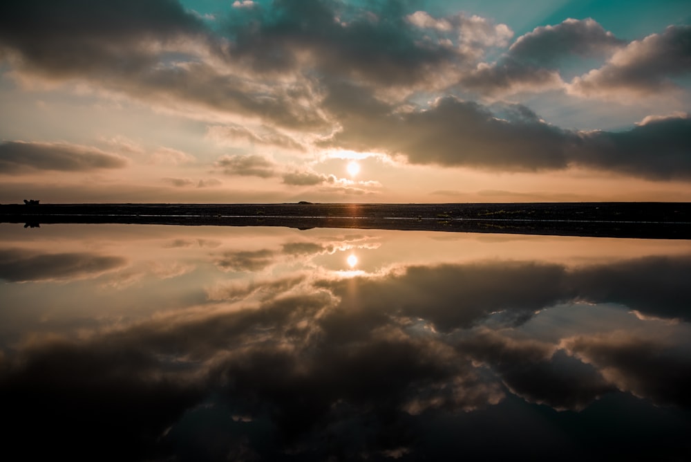 reflection of gray clouds on sea