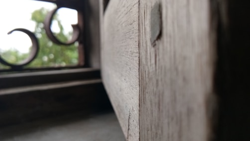 Close-up of finely crafted wooden window frames with natural grain visible.