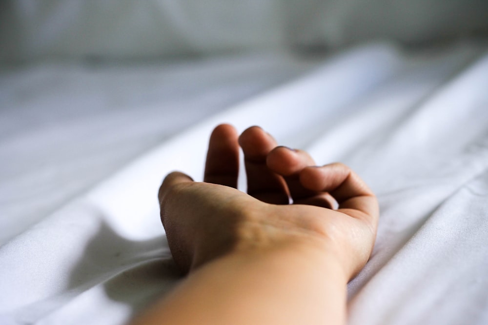 human hand on white textile