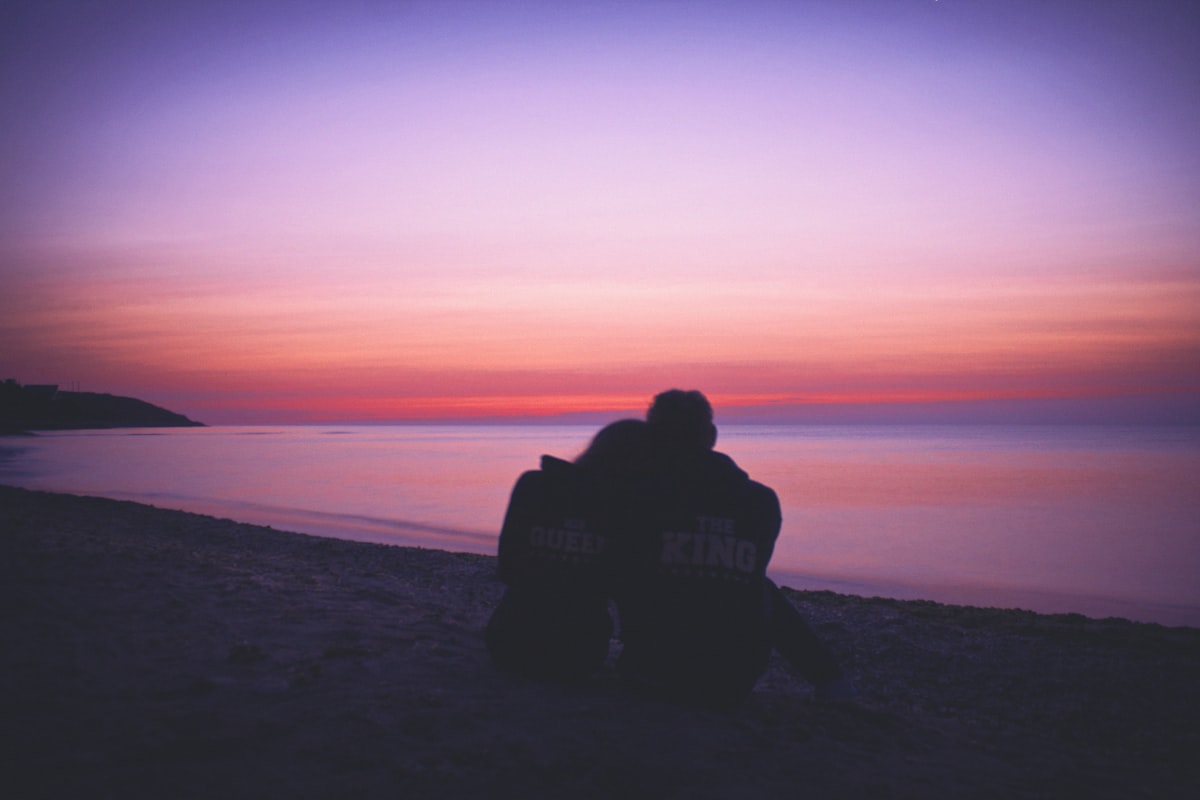 A couple sharing an affectionate embrace at sunset