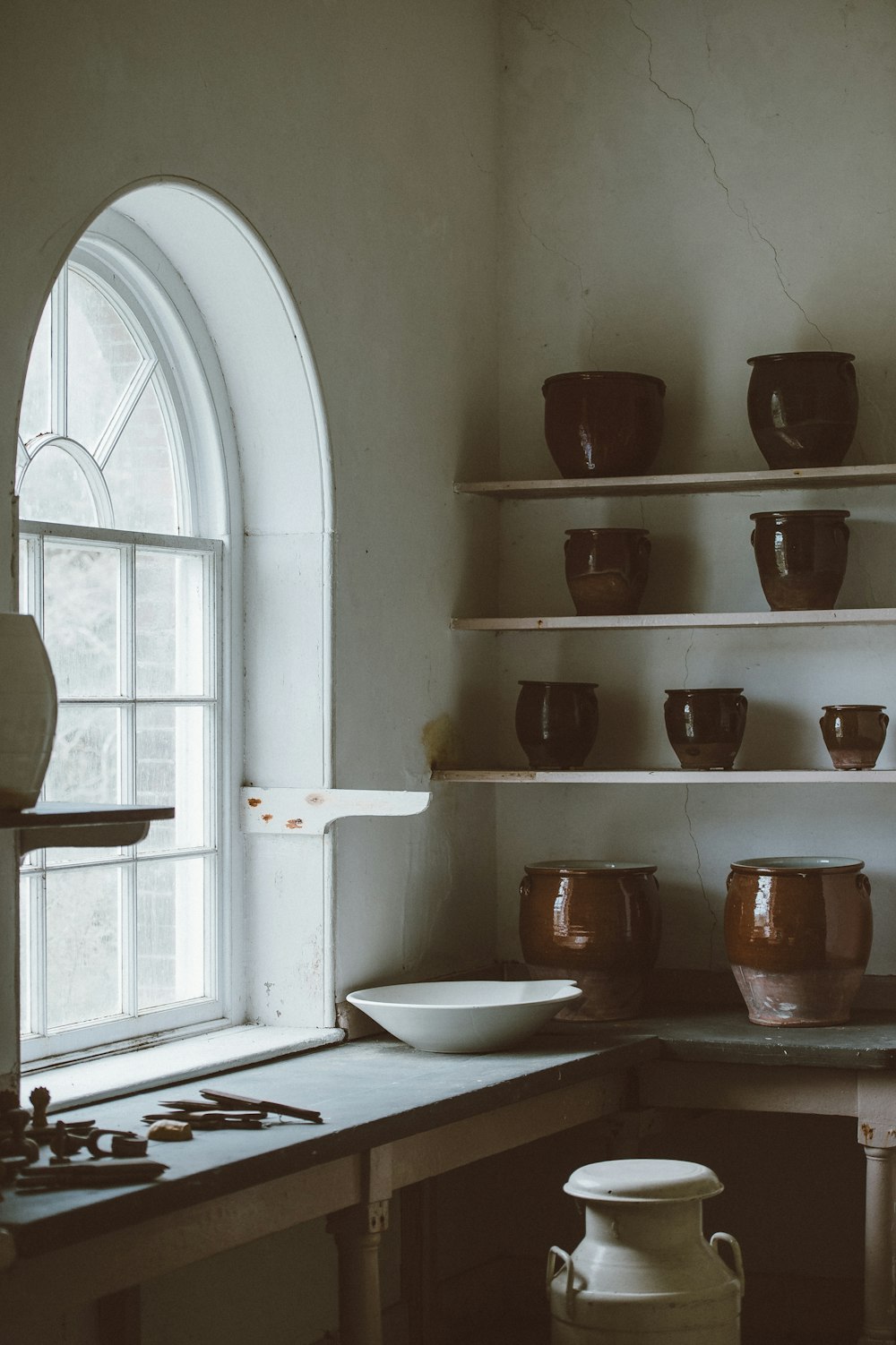 white ceramic bowl beside glass window