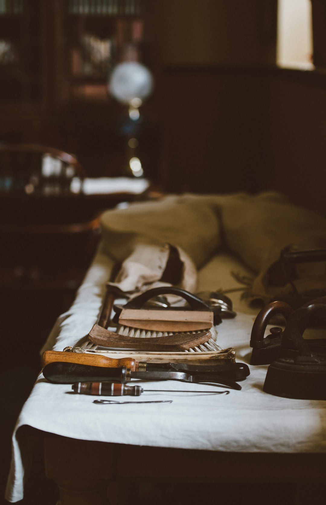 brown shoe brush on bed sheet