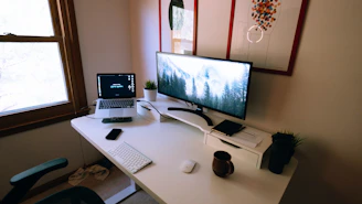 A clean, modern workspace featuring a laptop, smart gadgets, and cozy home accessories bathed in soft natural light