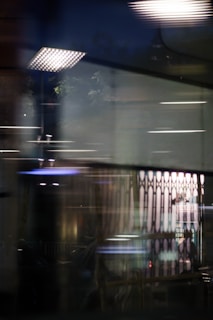 Abstract digital art of glitching cityscapes and fractured neon lines reflecting the dystopian soundscape.