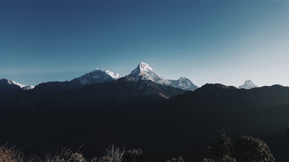 silhueta da montanha com vista da cordilheira coberta de neve durante a foto diurna