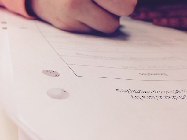 Close-up of hands holding a pen and marking important points on a study guide.