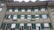 The building features a traditional architectural style with multiple windows equipped with green shutters. The signage indicates a pizzeria and pasticceria named 'Da Vinci'. The facade is beige, and there are several awnings above the windows, some of which are striped.