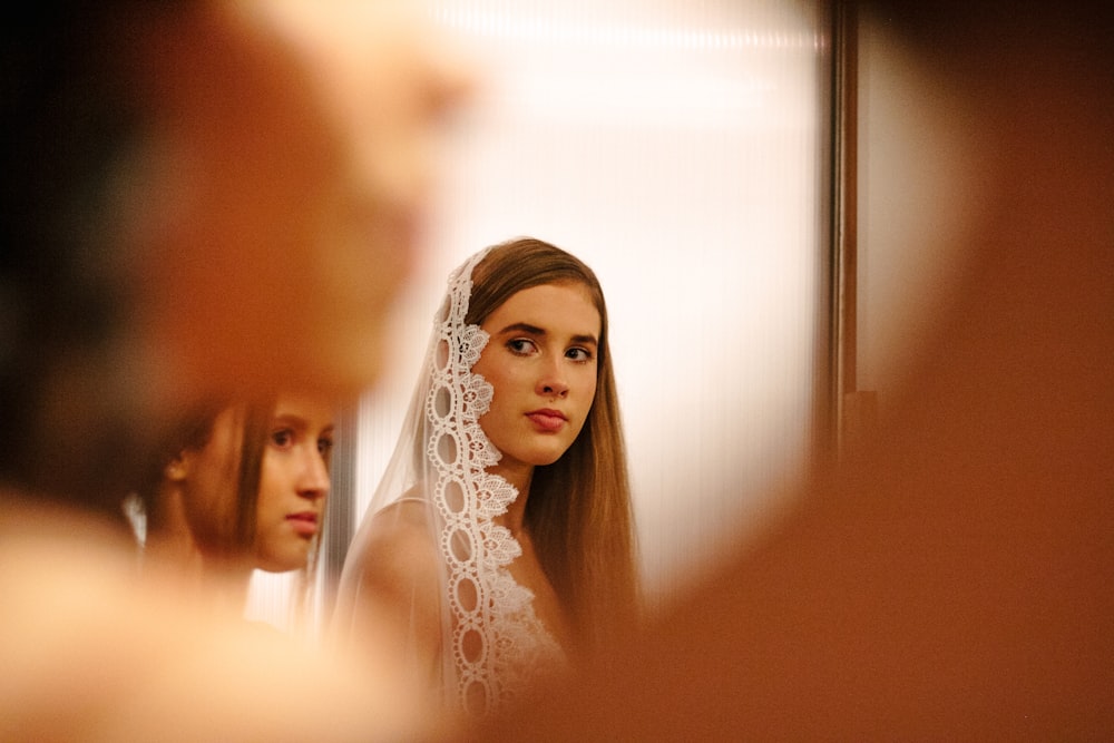 selective focus photo of woman wearing white veil