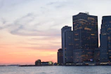 Skyline view of downtown Philadelphia with modern glass buildings glowing at dusk.
