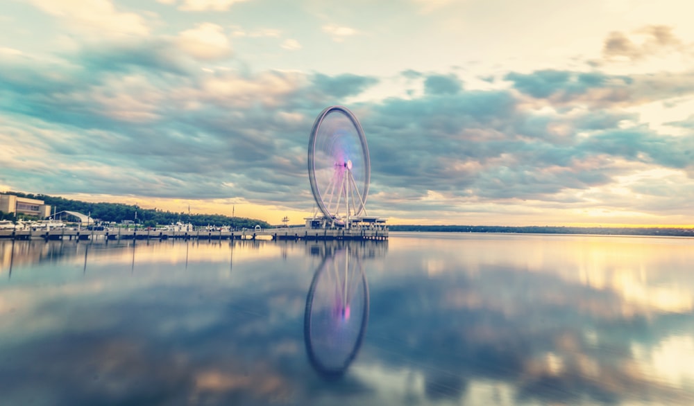 a ferris wheel sitting in the middle of a lake