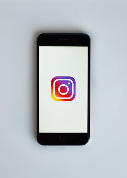 Cell phone with Instagram logo displayed on screen.