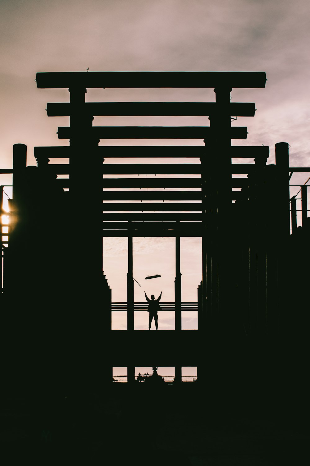 silhouette of person standing on scaffolding