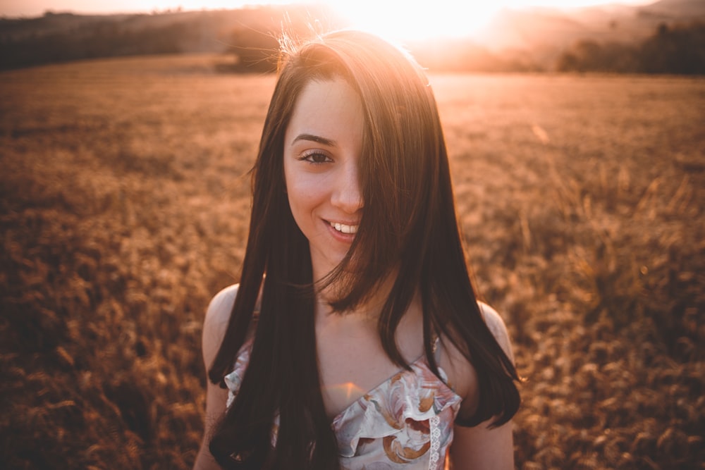 selective focus photography of woman on grass field