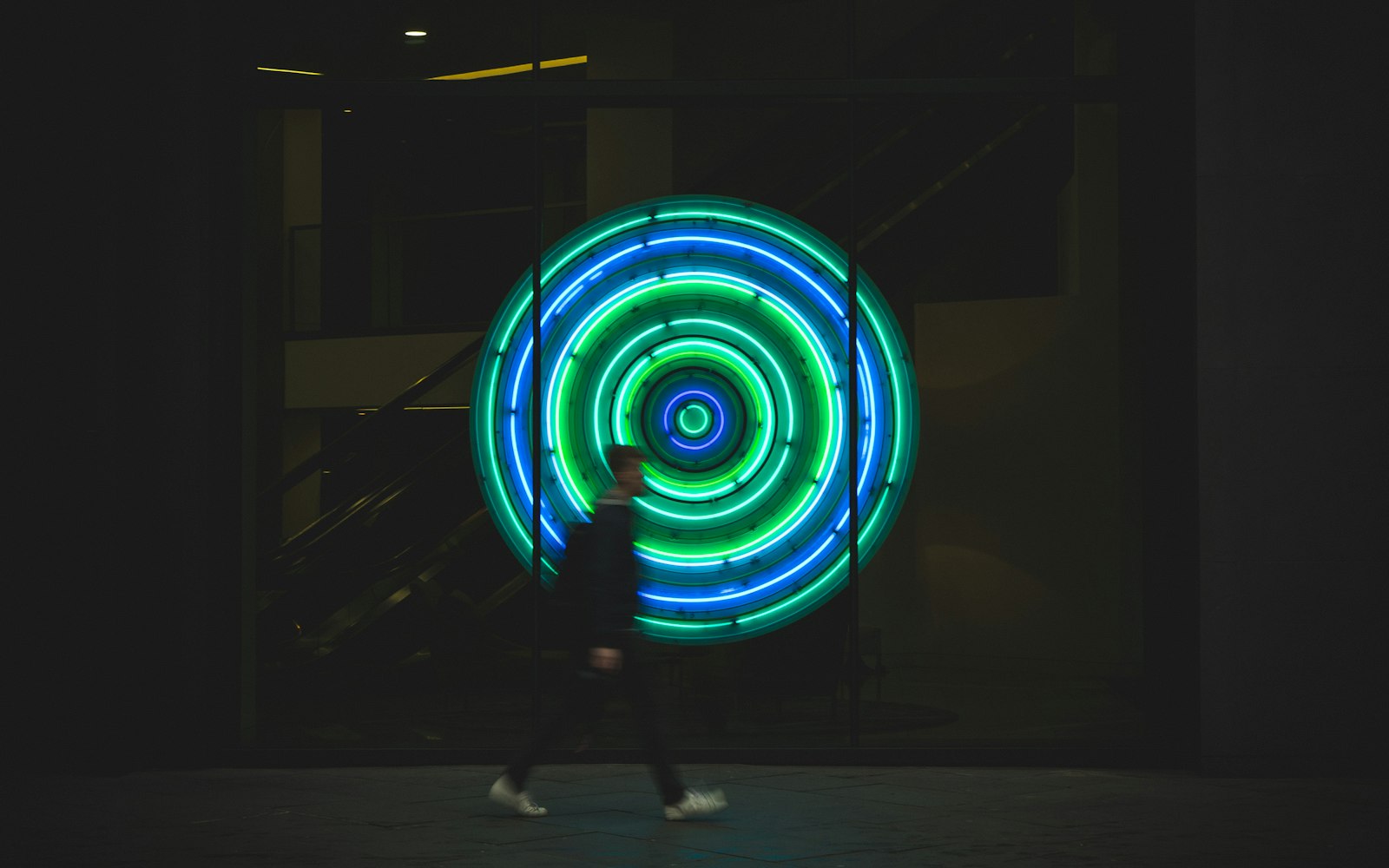 Sony a7 II + E 50mm F1.8 OSS sample photo. Man walking near neon photography