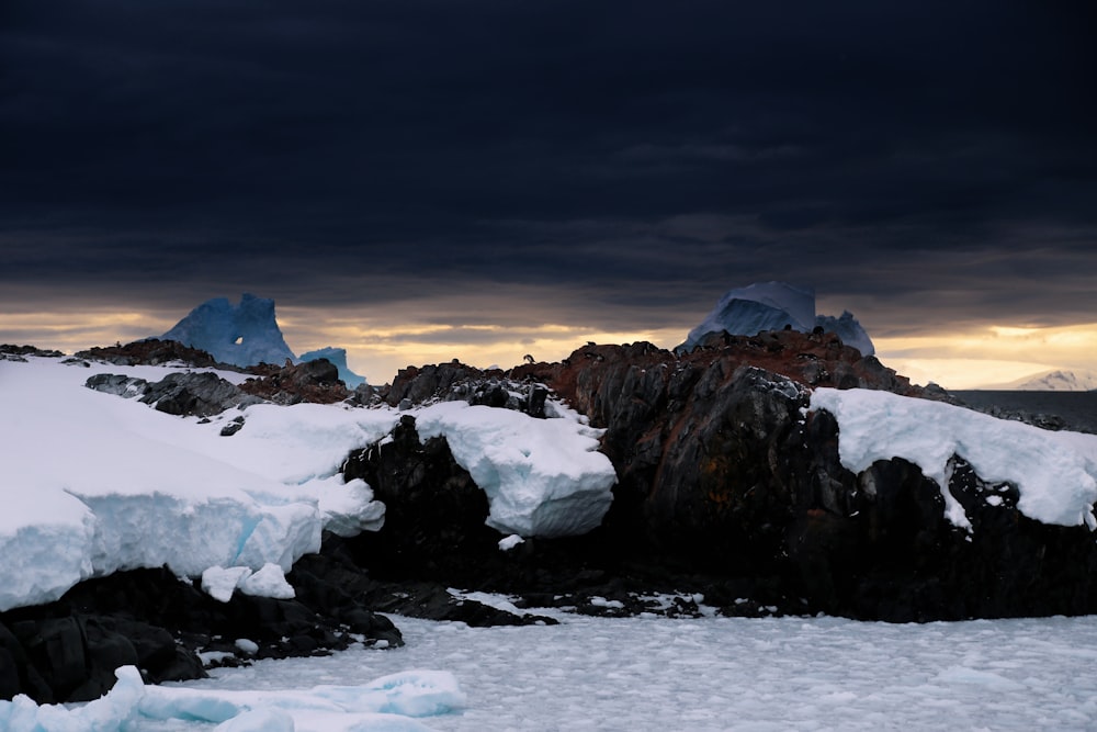 snow capped mountain under dark cloudy sky