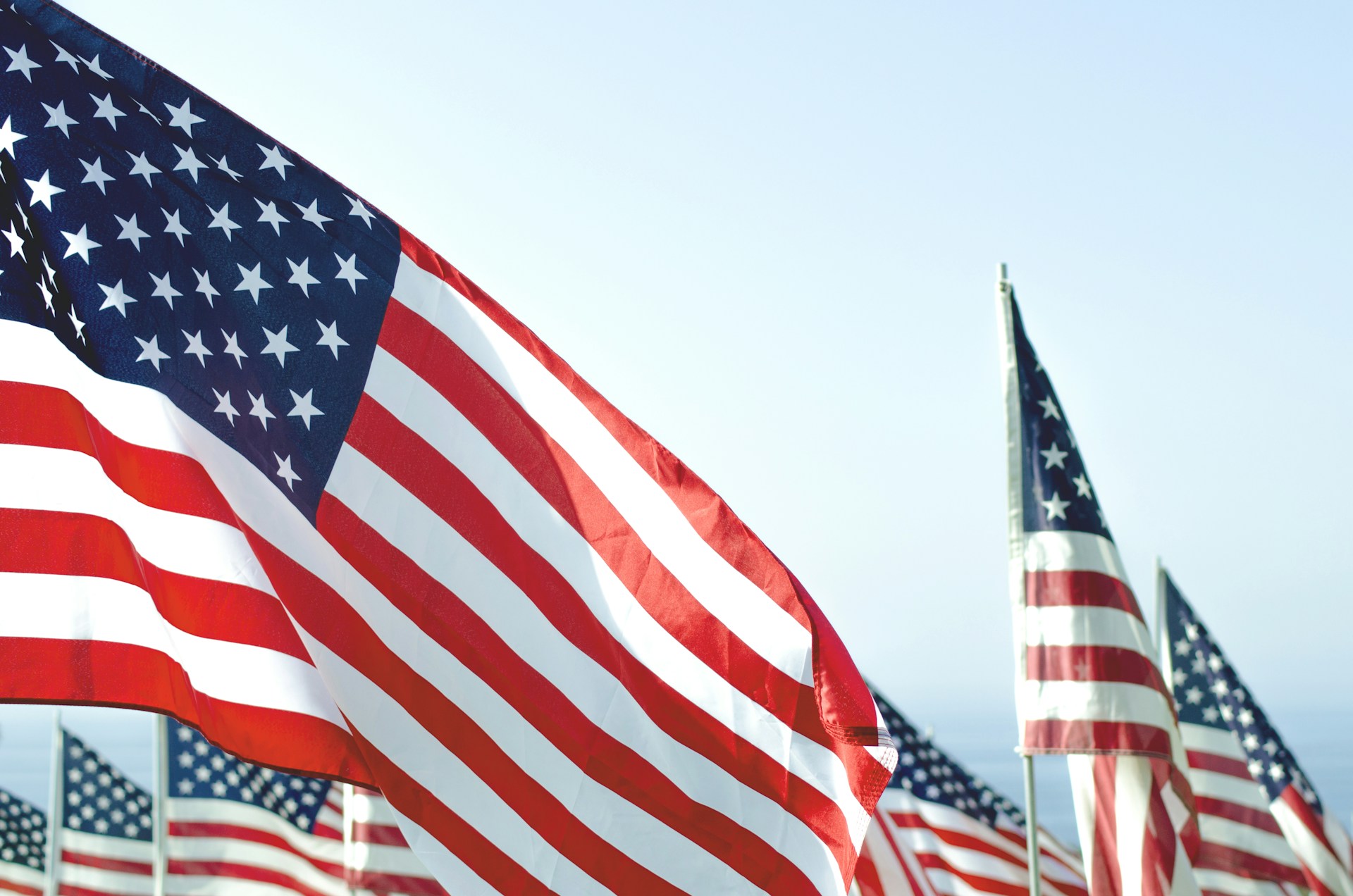 US flags under clear sky