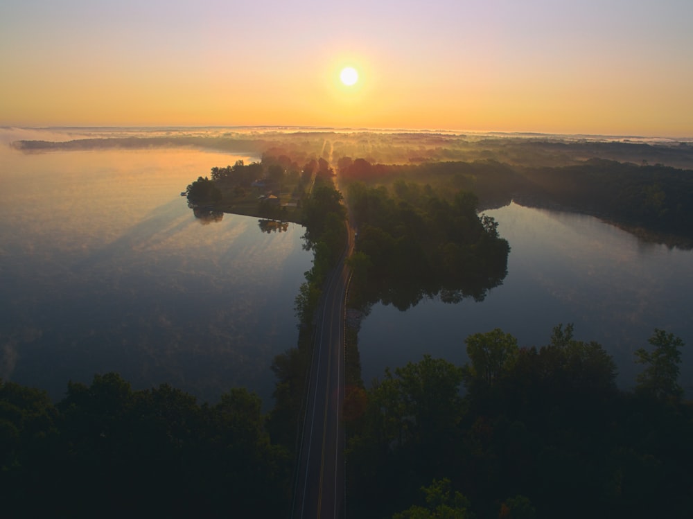 aerial photo of gray road between body of water