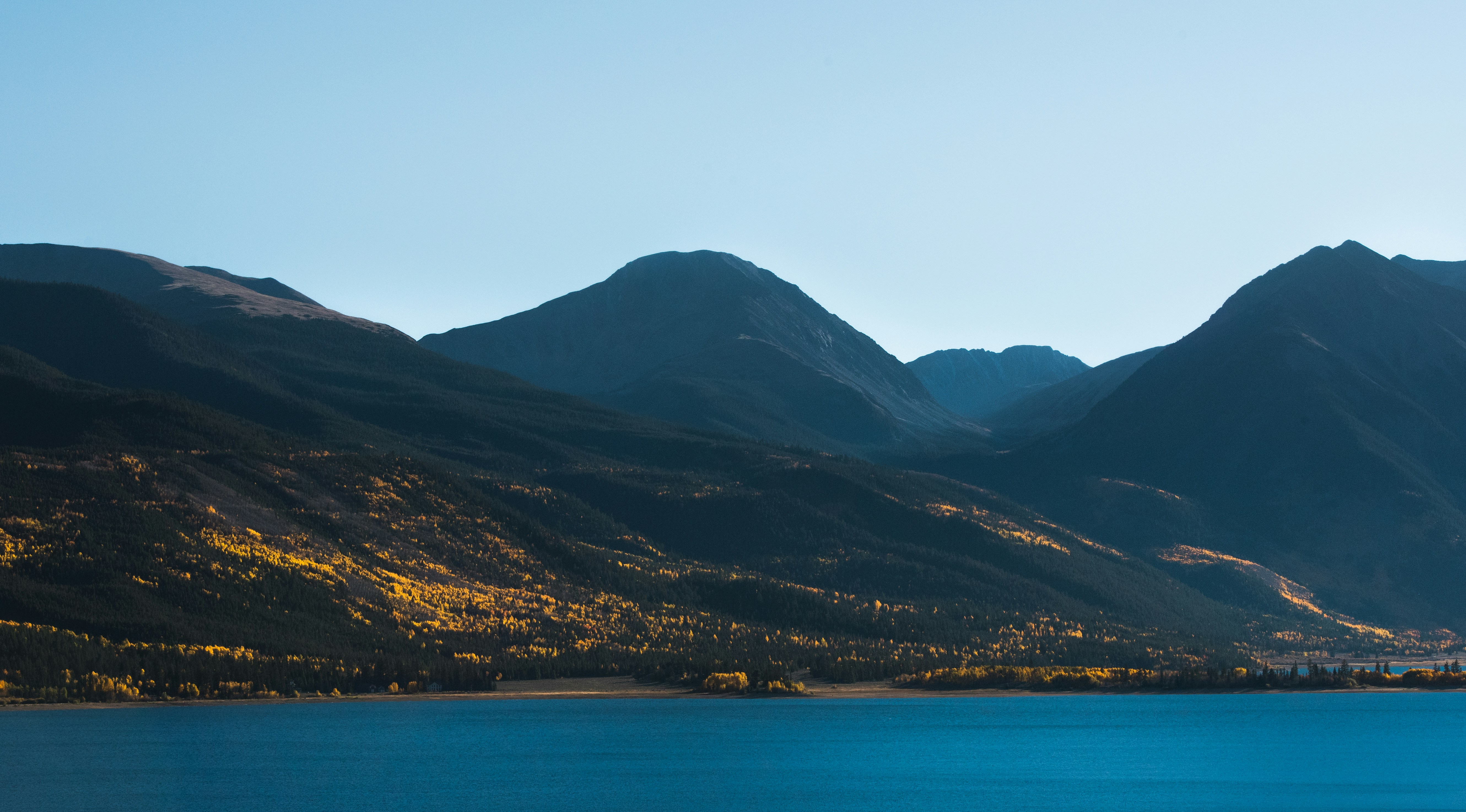 Stop image for Selkirk Loop: A 2-Day Motorcycle & Camping Adventure from Kaslo - body of water near mountain range -  in Kootenay Rockies, British Columbia, Canada - Photo by Nathan Anderson on Unsplash