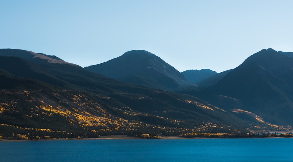 body of water near mountain range