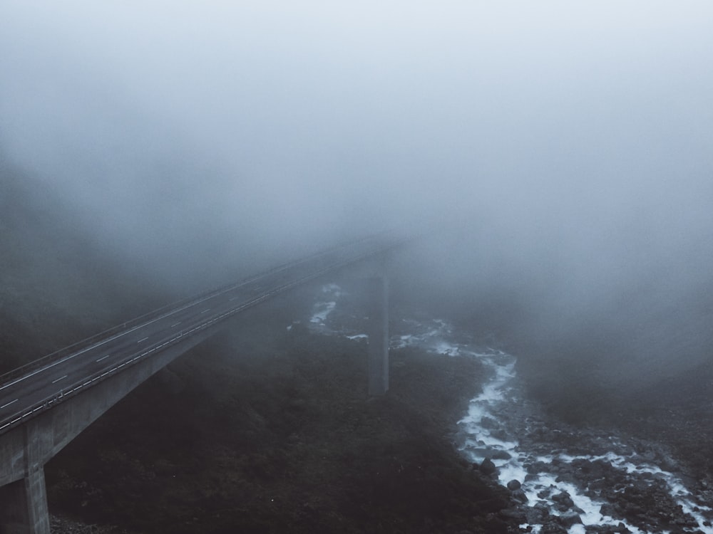 gray concrete bridge under body of water