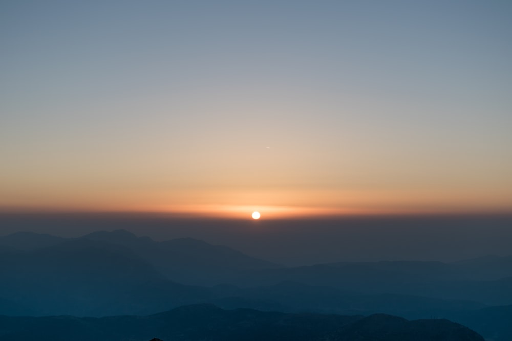 sunrise in front of mountain