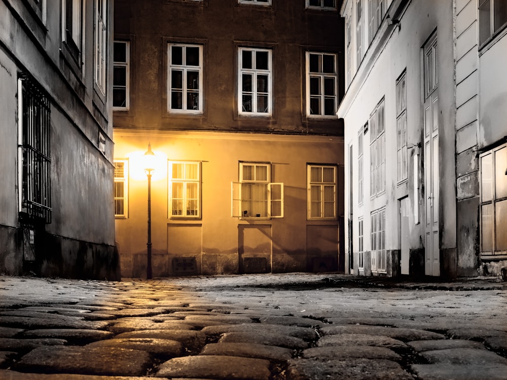 black street lamp near high-rise building during night time