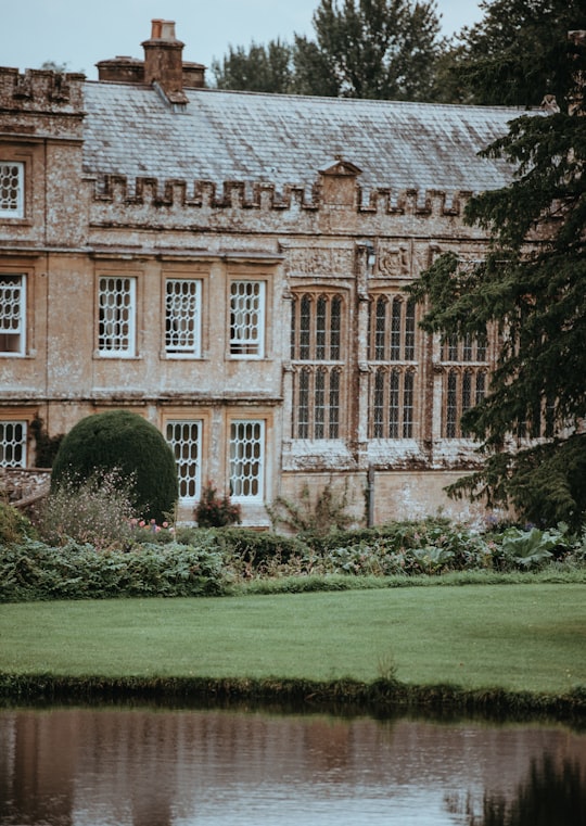 brown and gray concrete mansion near body of water in Forde Abbey United Kingdom