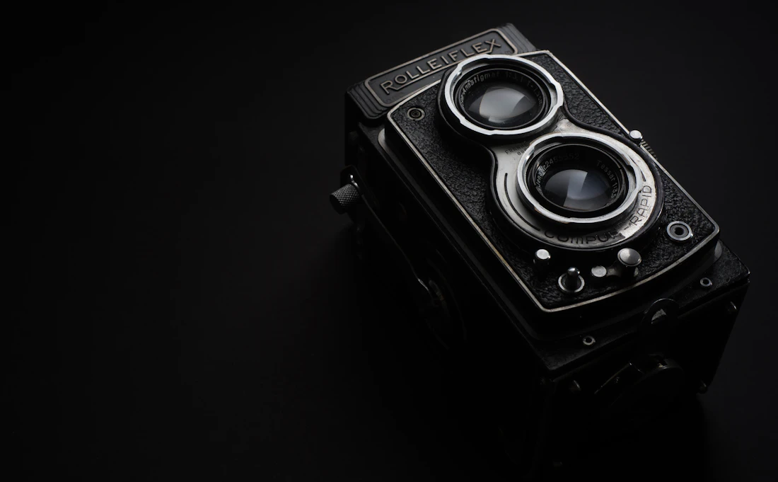 A cinema camera lit against a dark set, the kind of production we bring to every client build.