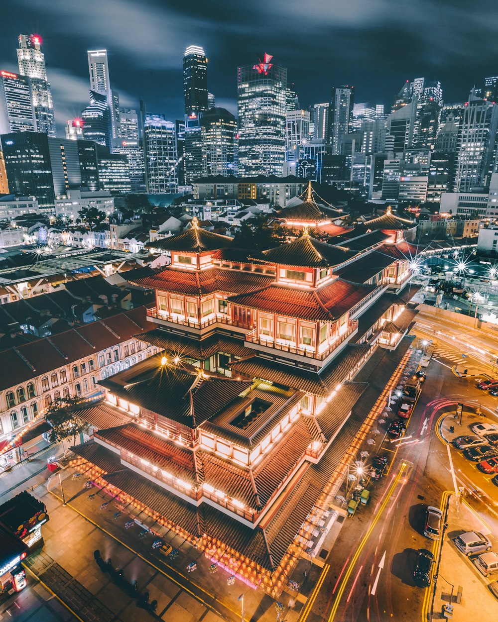 aerial photography of parked cars near building during night time