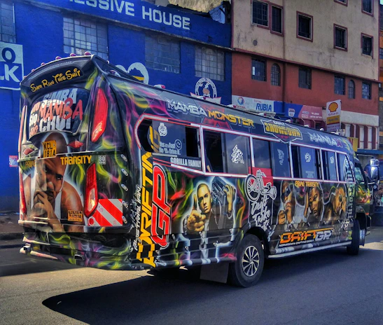 A vibrant city bus covered with colorful, eye-catching advertising promoting a local event.