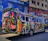 A brightly wrapped vehicle showcasing vibrant colors and sharp graphics on city streets.